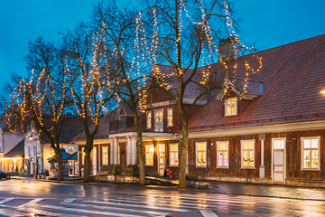 Image showing Kuressaare, Estonia. Old Wooden House In Tallinna Street At Evening Night. Street In Fesive Christmas Xmas New Year Illuminations