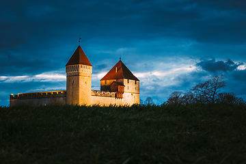 Image showing Kuressaare, Saaremaa Island, Estonia. Episcopal Castle In Evening Blue Hour Night. Traditional Medieval Architecture, Famous Attraction Landmark. Old Tower.