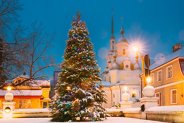 Image showing Parnu, Estonia. Christmas Tree In Holiday New Year Festive Illumination And St. Katherine Orthodox Church On Background