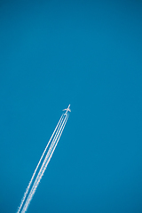 Image showing Airplane In The Sky With Plane Trails