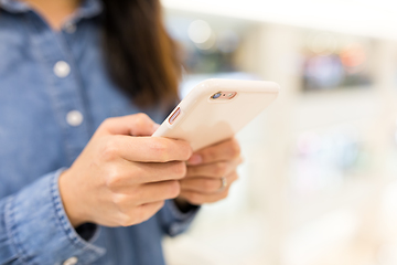 Image showing Woman sending sms on mobile phone