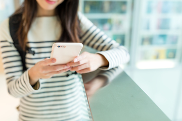 Image showing Woman checking something on cellphone