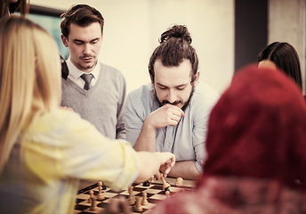 Image showing multiethnic group of business people playing chess