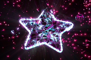 Image showing Bright beautiful glowing star on a Christmas tree in the evening