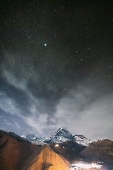 Image showing Stepantsminda, Georgia. Night Starry Sky With Glowing Stars Above Peak Of Mount Kazbek Covered With Snow. Night Lightning. Beautiful Georgian Landscape In Late Autumn. Stepantsminda, Georgia. Night S