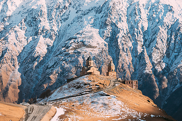 Image showing Stepantsminda, Gergeti, Georgia. Iconic Famous Gergeti Trinity Tsminda Sameba Church In Early Winter Landscape. Beautiful Georgian Mountains Landscape