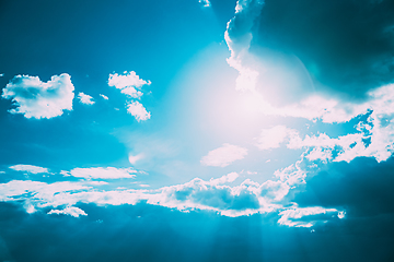 Image showing Sunrays Sunray Shine Through Dark Clouds In Cloudy Blue Sky. Natural Background. Natural Sky Backdrop Weather Conditions. Cloudy Sky With Fluffy Clouds. Sunset Sky Natural Background. Sunrays, sunray