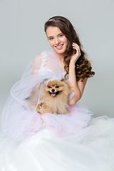 Image showing beautiful bride girl with spitz bride on gray background