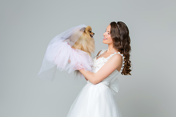 Image showing beautiful bride girl with spitz bride on gray background