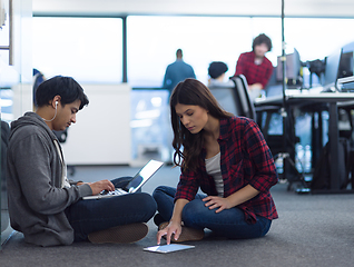 Image showing young software developers couple working on the floor