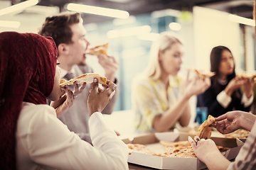 Image showing multiethnic business team eating pizza