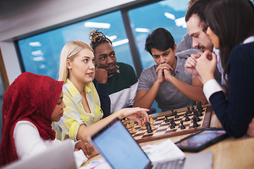 Image showing multiethnic group of business people playing chess