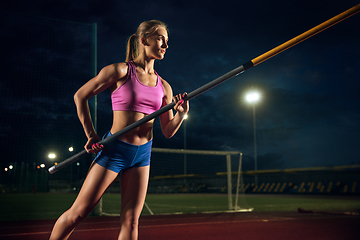 Image showing Female pole vaulter training at the stadium in the evening