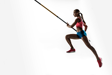 Image showing Female pole vaulter training on white studio background