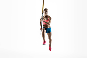 Image showing Female pole vaulter training on white studio background