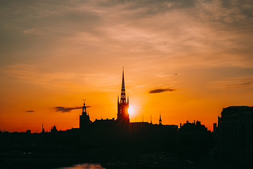 Image showing Stockholm, Sweden. Sunset Sun Shine Through Dark Silhouette Of Riddarholm Church In Stockholm Skyline. Scenic View Of Gamla Stan Old Town In Dramatic Sunshine Sunlight. Popular Destination Scenic