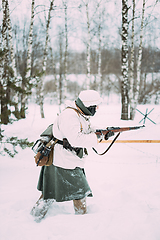 Image showing German Wehrmacht Infantry Soldier In World War II Attacking With Rifle In Winter Day. Historical Re-enactment. WWII.