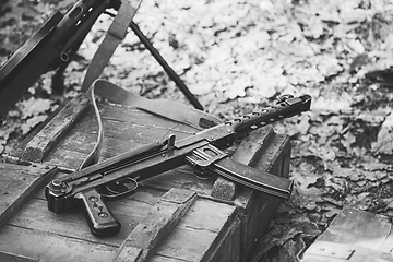 Image showing Old Soviet Russian Red Army Submachine Gun PPS-43 Weapon Gun Of World War II Lying On The Wooden Box. Black And White Photo