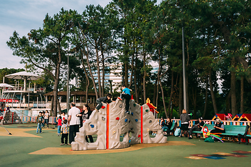 Image showing Batumi, Adjara, Georgia. Children and adults play on playground on city street near waterfront.