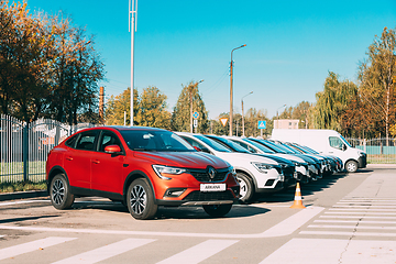 Image showing Different Renault Cars Arkana And Kaptur parking in row outdoors. Subcompact Crossovers Produced Jointly By Renault Nissan Alliance. Cars Parked Near Dealership.