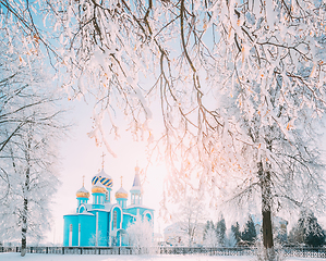 Image showing Village Krasnoe, Gomel Region, Belarus. Old Orthodox Church Of The Assumption At Sunny Winter Snowy Day. Famous Landmark In Snowy Park.