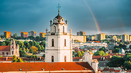 Image showing Vilnius, Lithuania. Sunset Cityscape Of Vilnius, Lithuania In Summer. Beautiful View Of Old Town In Evening. Sts Johns\' Church Sv. Jonu baznycia . Altered Sky With Rainbow