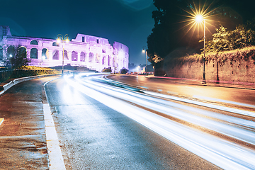 Image showing Rome, Italy. Colosseum View From Another Side In Night Time. Night Traffic Light Trails Near Famous World Landmark