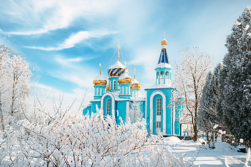 Image showing Village Krasnoe, Gomel Region, Belarus. Old Orthodox Church Of The Assumption At Sunny Winter Snowy Day. Famous Landmark In Snowy Park.