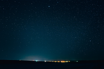 Image showing Landscape With Natural Night Sky Stars Background. Starry Sky Over Town