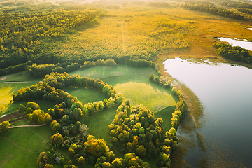 Image showing Aerial View Of Green Forest And Meadow Hill Landscape Near River. Top View Of Beautiful Nature From High Attitude.