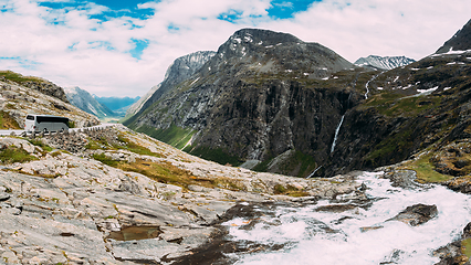 Image showing Trollstigen, Andalsnes, Norway. Bus Goes On Road Near Stigfossen Waterfall. Famous Mountain Road Trollstigen. Norwegian Landmark And Popular Destination. Norwegian County Road 63 In Sunny Summer Day