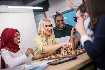 Image showing multiethnic group of business people playing chess