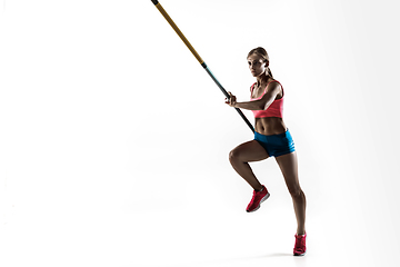 Image showing Female pole vaulter training on white studio background