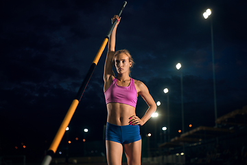 Image showing Female pole vaulter training at the stadium in the evening