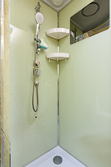 Image showing At the back wall of the shower stall on which the mixer and shower are located the glass cracked