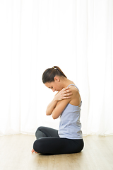 Image showing Portrait of gorgeous active sporty young woman practicing breathing exercises in yoga studio. Healthy active lifestyle, working out indoors in gym