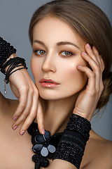 Image showing beautiful girl with many black bracelts