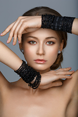 Image showing beautiful girl with many black bracelts