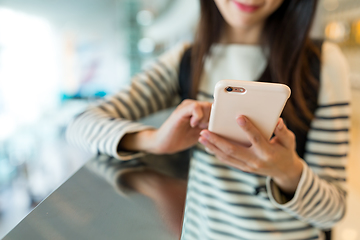 Image showing Woman checking something on mobile phone