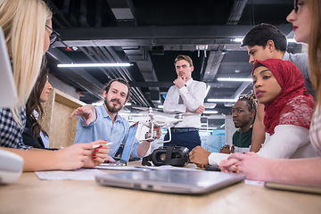 Image showing multiethnic business team learning about drone technology