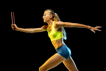 Image showing Professional female relay racer training on black studio background in neon light