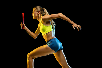 Image showing Professional female relay racer training on black studio background in neon light