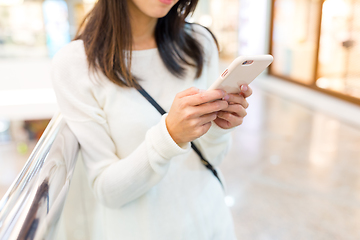 Image showing Woman sending text message on cellphone