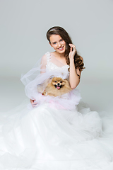 Image showing beautiful bride girl with spitz bride on gray background