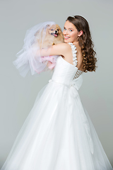 Image showing beautiful bride girl with spitz bride on gray background