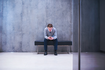 Image showing businessman using smart phone while sitting on the bench