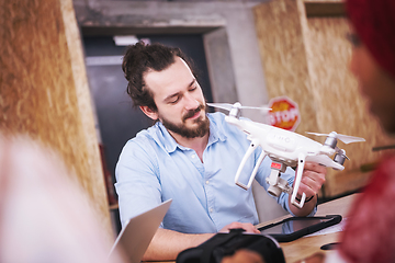 Image showing multiethnic business team learning about drone technology