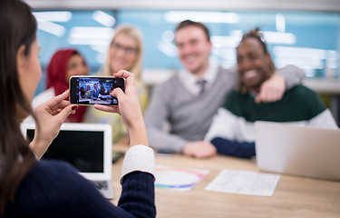 Image showing businesswoman using mobile phone for taking photo