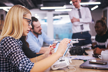 Image showing blonde business woman learning about drone technology