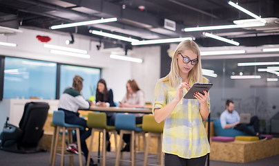 Image showing blonde businesswoman working online using digital tablet